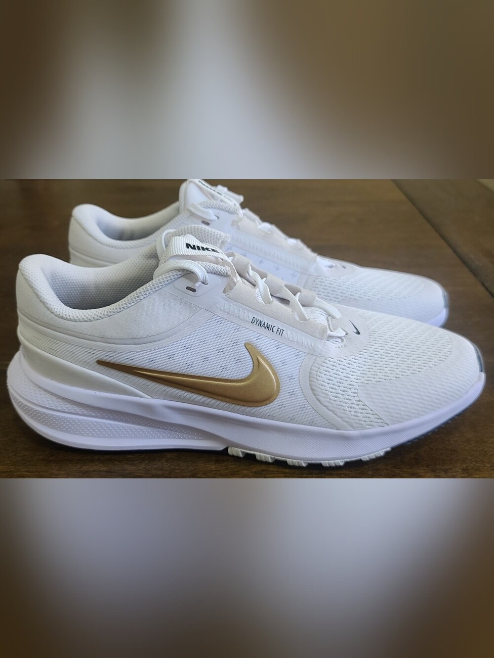 Nike Women's White Athletic Shoes with Gold Swoosh